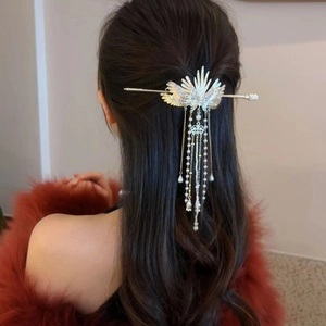 Detail of silver phoenix wing hair pin with long tassel and pearls on model