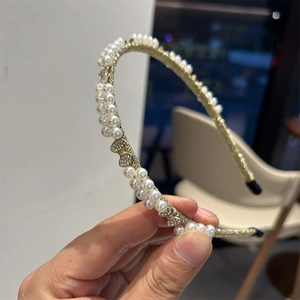Elegant baroque pearl headband with gold base and heart bow rhinestone accents