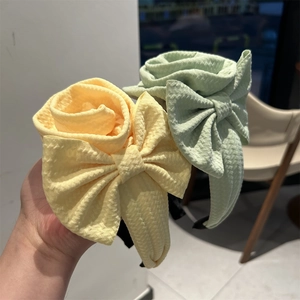 Detail of floral fabric headband with bubble texture in yellow and mint green
