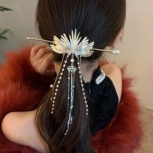 Detail of wing tassel hair stick with rhinestones and pearls on model back view