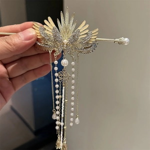 Elegant gold wing hair pin with white tassels, pearls, and crystals for traditional styling