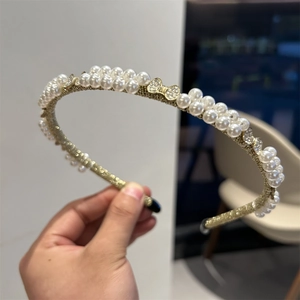 Baroque style gold headband with double row white pearls and sparkling rhinestone bows