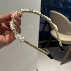 Elegant Baroque style gold braided headband featuring white pearls and sparkling rhinestones