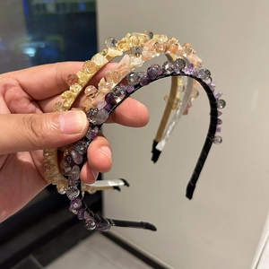 Close-up of handmade luxury crystal headbands in purple, pink and yellow rhinestone sets