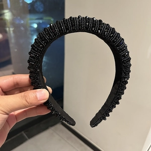 Detailansicht des handgefertigten schwarzen Perlenstirnbands mit glänzenden Perlen
