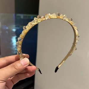 Detailed close-up of handmade champagne crystal headband with sparkling yellow gemstones