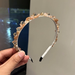 Detailed view of handmade beaded headband with amber stones and clear faceted glass crystals