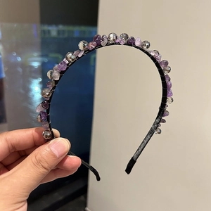 Detail of handcrafted headband featuring purple amethyst stones and crystal beads