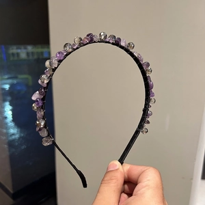Handmade headband featuring purple crystals and grey glass beads on a black metal frame