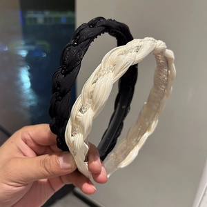 Elegant twisted crystal headbands in black and beige with sparkling beaded details