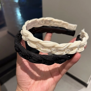 Detail of woven fabric headband with sparkling beads and non-slip inner teeth
