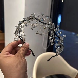 Macro detail of handmade beaded headband featuring smoky gray crystals and woven wire design