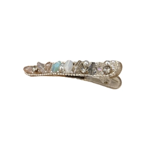 Elegant champagne gold hair clip with pearls and sparkling crystals on a white background