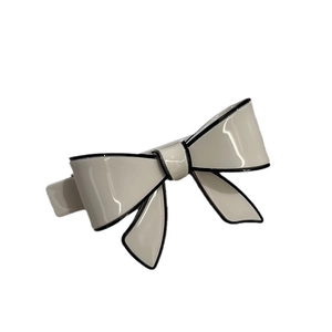 Elegant cream acetate bow hair clip with black edges and polished mirror finish hair accessory