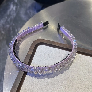 Close-up of purple headband with clear prism crystals and black non-slip inner teeth