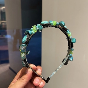 Elegant handcrafted crystal headband featuring green and blue beads on a non-slip frame