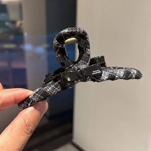 Elegant black and white plaid hair claw clip with a stylish bow for women's updos