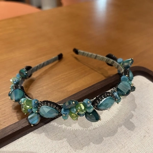 Elegant crystal headband with green and blue beads on a premium silver-gray fabric base