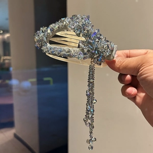 Elegant crystal hair claw with iridescent blue-grey stones and long beaded tassels