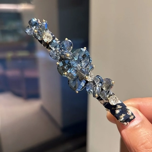 Handmade crystal beaded hair clip featuring deep blue beads and vintage floral fabric