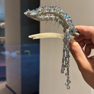 Detailed view of banana clip with crystal floral patterns and cascading tassel beads