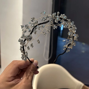 Macro detail of handmade crystal headband showing intricate wire weaving and blue beads