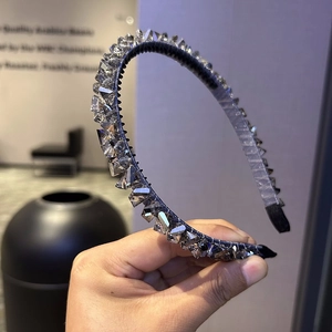 Detailed macro view of dark grey faceted crystals on a slim handmade hairband