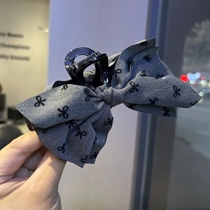 Chic grey fabric bow hair claw clip with black pattern for elegant bun hairstyles