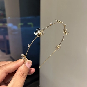 Elegant gold double-layered headband with hollow flower patterns and sparkling zircons