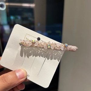 Pink crystal hair clip with iridescent rhinestones on a white display card for girls