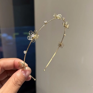 Elegant gold metal headband with hollow flower designs and sparkling zircon crystals