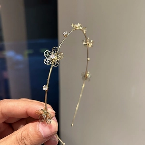 Elegant gold metal headband with hollow floral designs and sparkling zircon crystals
