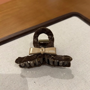 Detailed view of brown checkered fabric hair claw clip with cream bow and France handmade text