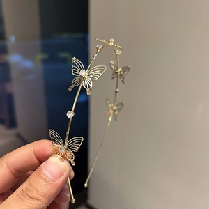Detail of gold butterfly headband with hollow carvings and sparkling zircon stones