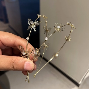Detailed close-up of golden hollow butterfly headband with sparkling cubic zirconia crystals
