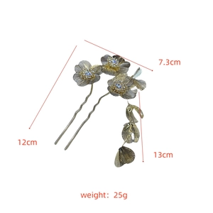 Detailed macro view of golden flower hair pins with tassel and crystal inlay measurements