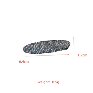 Detailed size view of an oval rhinestone hair clip with dimensions 6.4cm by 1.7cm