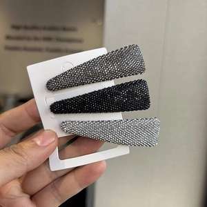 Three-piece set of sparkling rhinestone snap hair clips in black, silver, and grey shades