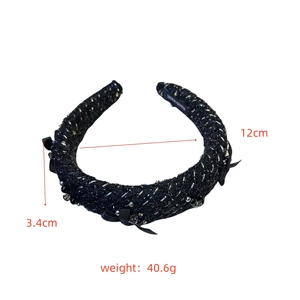 Detail view of tweed headband with bead trim showing 3.4cm width and 12cm diameter