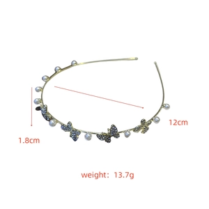 Detailed view of elegant gold metal headband with pearls and rhinestones butterflies