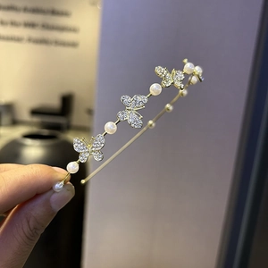 Elegant gold metal headband featuring sparkling rhinestone butterflies and white pearls