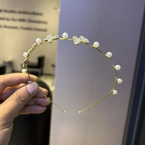 Elegant gold thin headband featuring delicate pearls and rhinestone butterfly charms