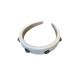 Elegant white padded headband with black camellia flowers and pearls on white background