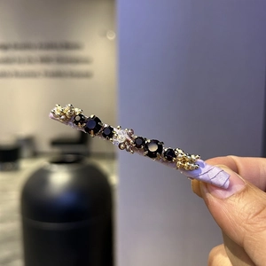 Handmade hair clip featuring purple crystals and gold beads on a lavender satin base