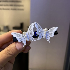 Elegant butterfly hair clip with cream acrylic, white pearls and sparkling rhinestones