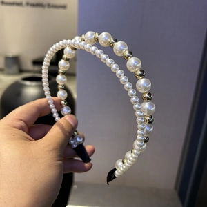 Detail of elegant double-layered headband with creamy pearls and champagne gold beads