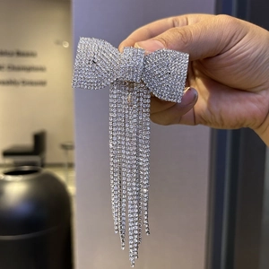 Sparkling diamond bow hair clip with silver rhinestone tassels for evening party hairstyles