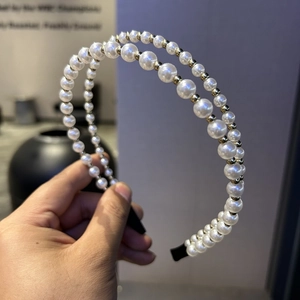 Detail of double-layer headband featuring white imitation pearls and gold metallic beads