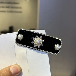 Elegant black velvet hair clip with sparkling rhinestones and center pearl snowflake detail