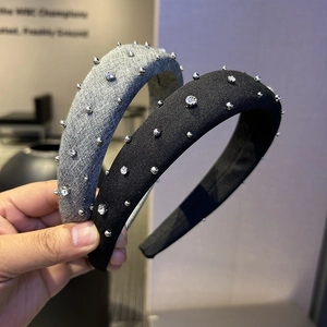 Detail of fabric headband with silver studs and sparkling rhinestones in grey and black